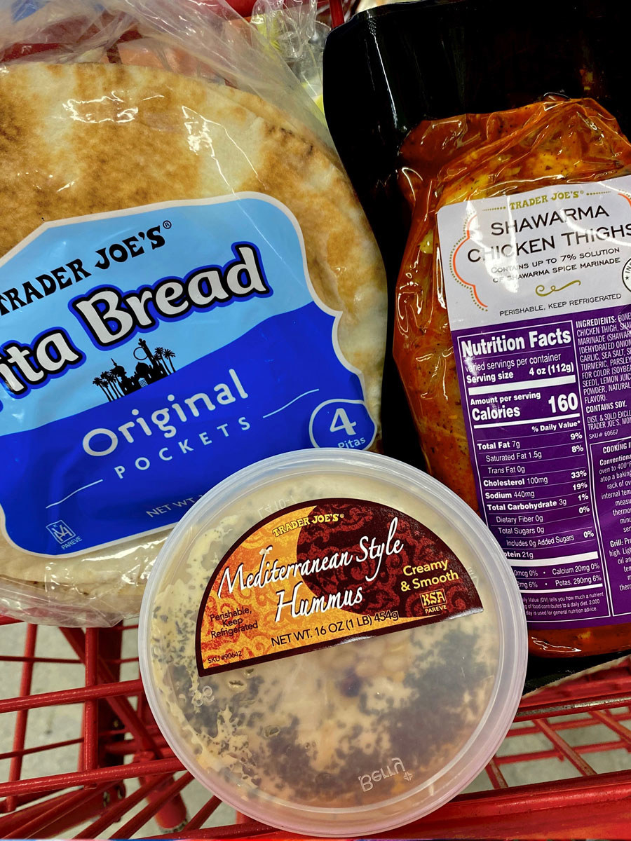 Mediterranean-style hummus, pita bread, and shawarma chicken thighs in a shopping cart.