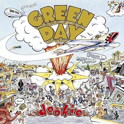 album cover of Dookie showing a drawing of a bunch of people and a giant explosion in the center as a plane flies way
