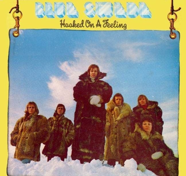 album cover of Hooked on a Feeling showing Blue Swede in fur coats in the clouds