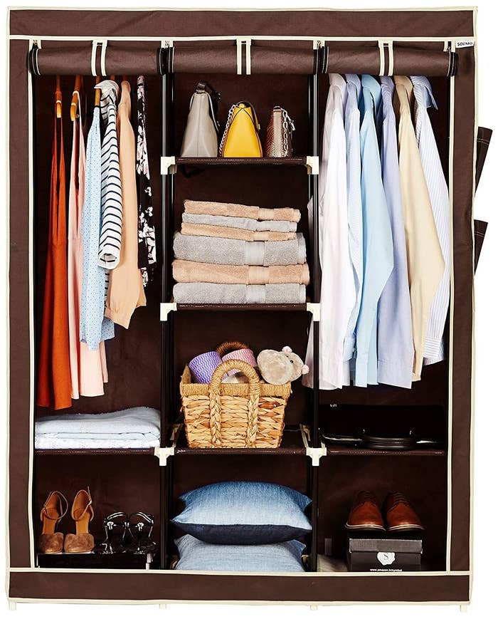 The foldable wardrobe with clothes in it