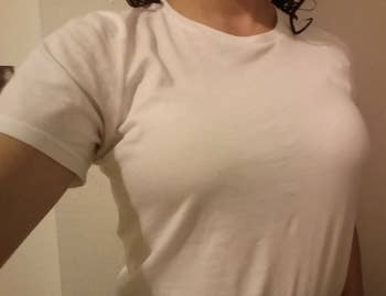 reviewer wearing white t-shirt with no bra visible underneath 