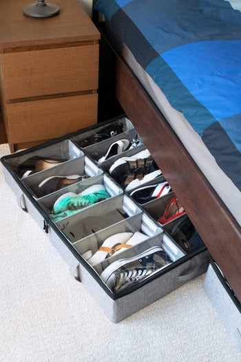 The shoe organizer being stored under a bed 