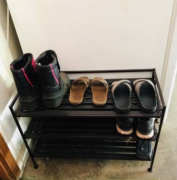 a reviewer's photo of their shoes on the shoe rack