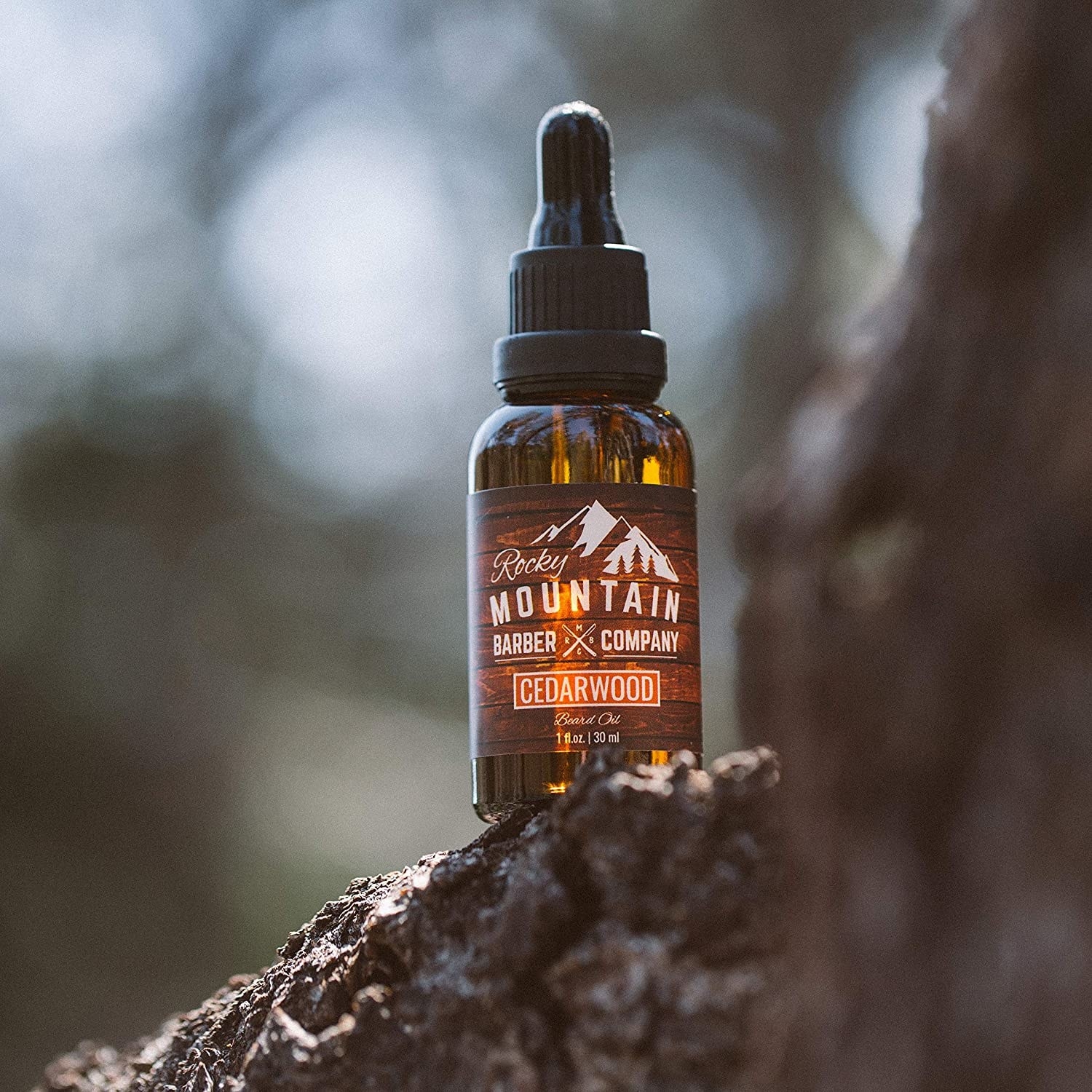 A bottle of the beard oil on a mountain rock