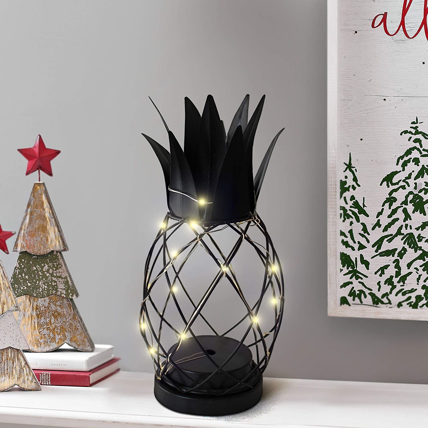 A black wire lamp in the shape of a pineapple.