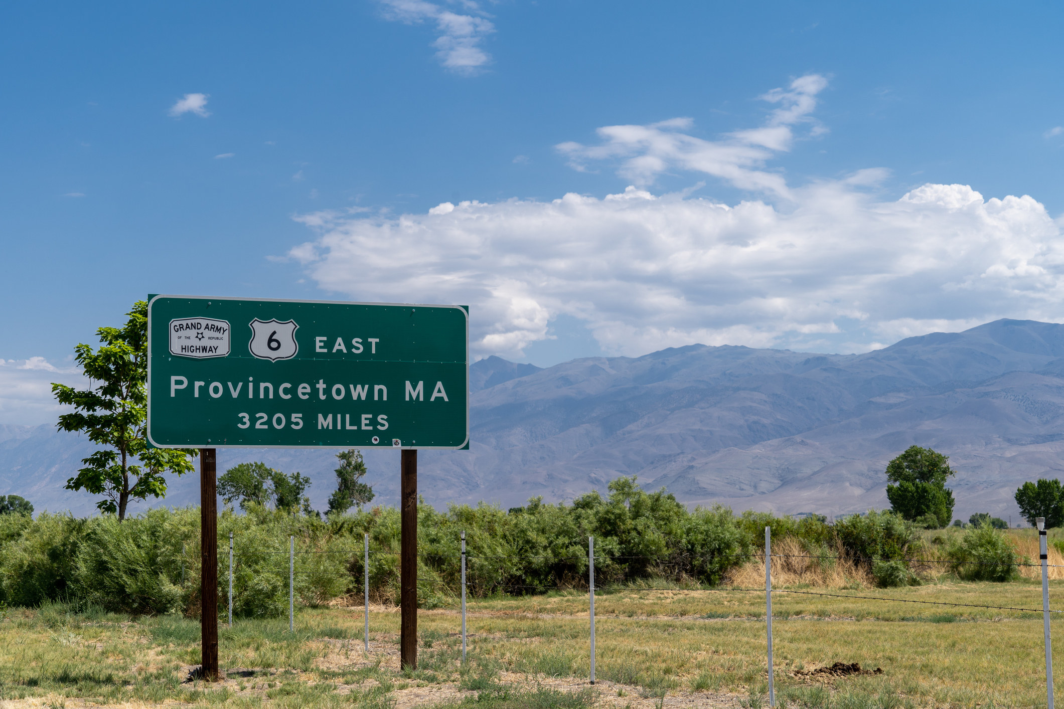 Sign for the Grand Army of the Republic Highway, noting that the end of the highway located in Provincetown Massachusetts is over 3000 miles away from Bishop California