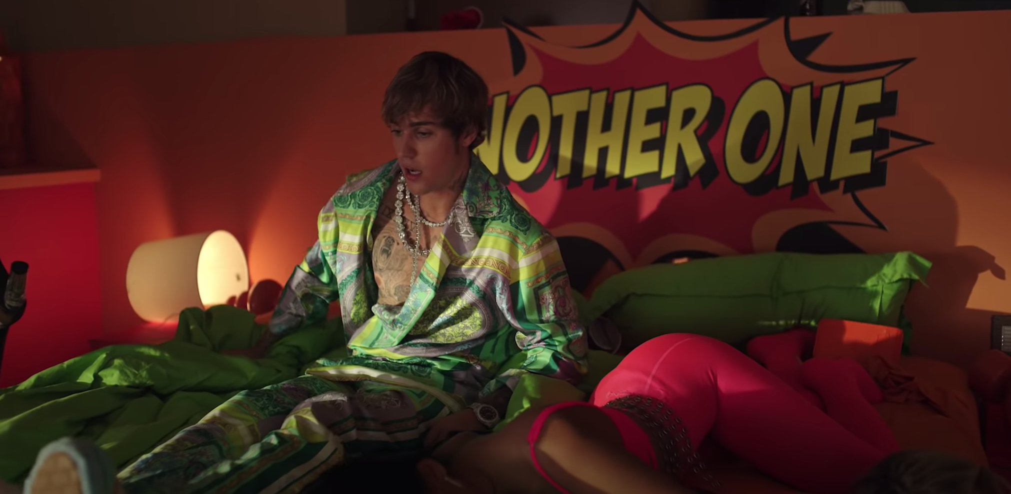 Justin wakes up in a bed with a room full of women after a wild night