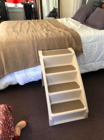 reviewer photo of a set of dog steps leading to a bed