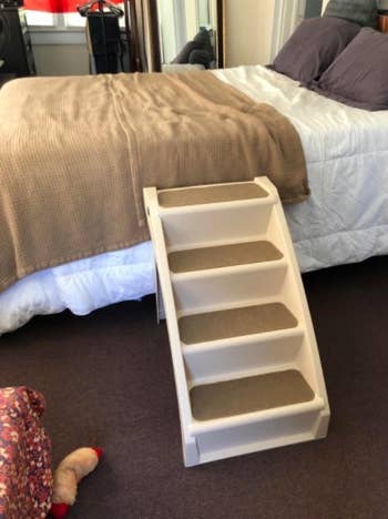 reviewer photo of a set of dog steps leading to a bed