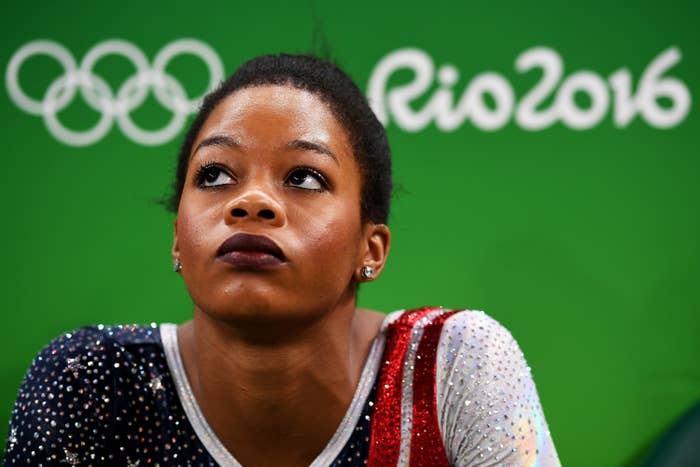 Gabby Douglas looking up towards the sky with her hair in a ponytail