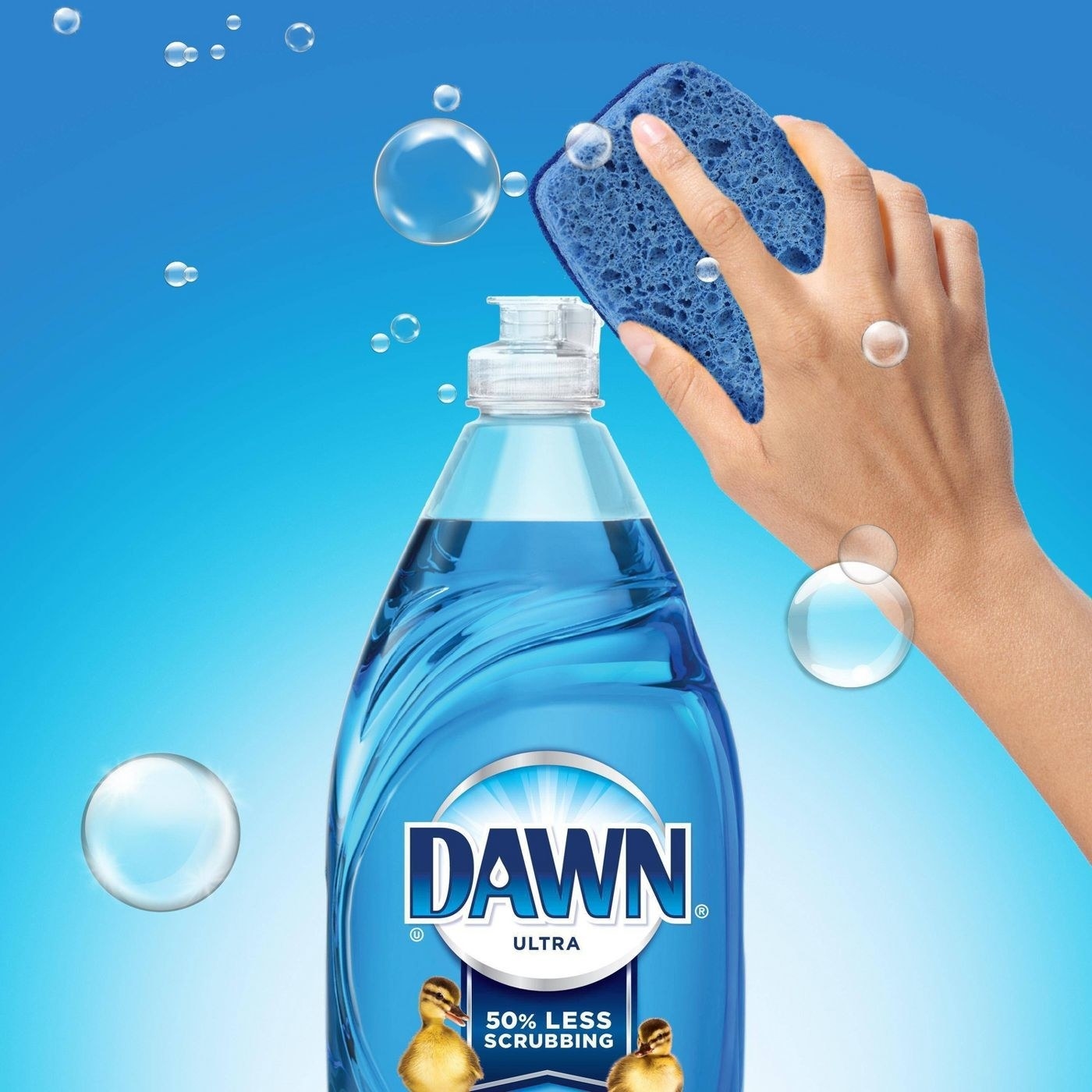 Bottle of blue dish soap with hand and sponge above it