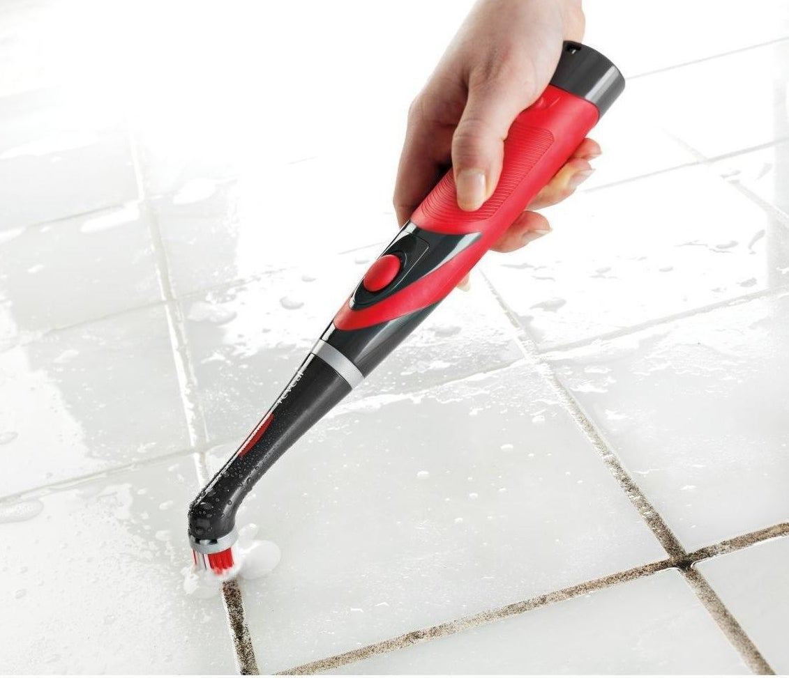 Model using power scrubber to clean grout