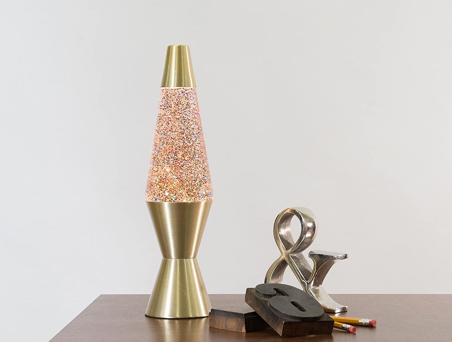 A lava lamp on a desk with glitter inside of it