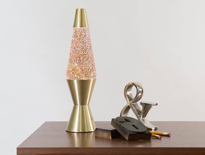 A lava lamp on a desk with glitter inside of it