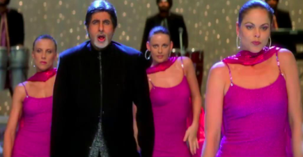 amitabh bachchan dances, with several other background dancers, to the tunes of shava shava