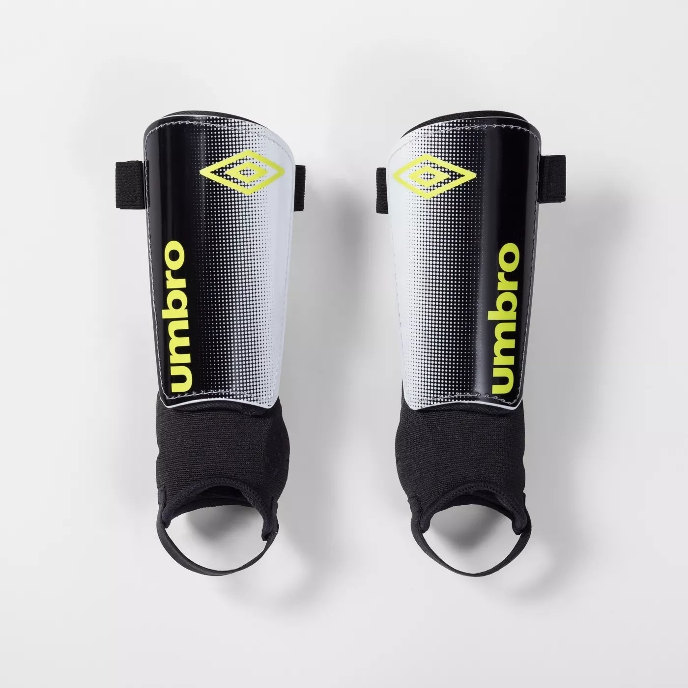 Black shinguards with the &quot;umbro&quot; logo and tag in green