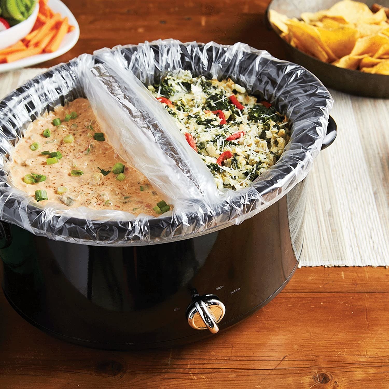 A slow cooker pot that&#x27;s divided in two with thin pot liners