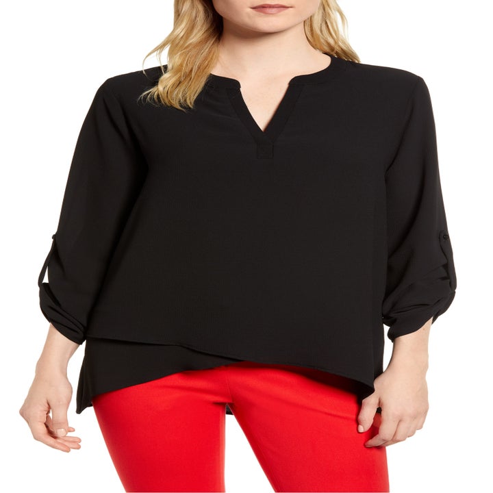 model wearing sleeved black V-neck top 