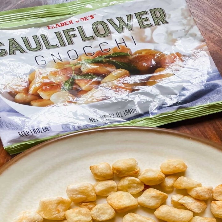 A bag of frozen Cauliflower gnocchi and some more gnocchi in a bowl.