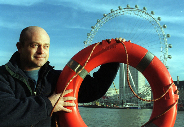 Man holding red life ring in london outside the london eye wheel