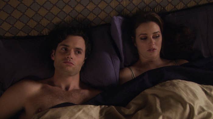 Dan and Blair from &quot;Gossip Girl&quot; under bedsheets looking dissatisfied 