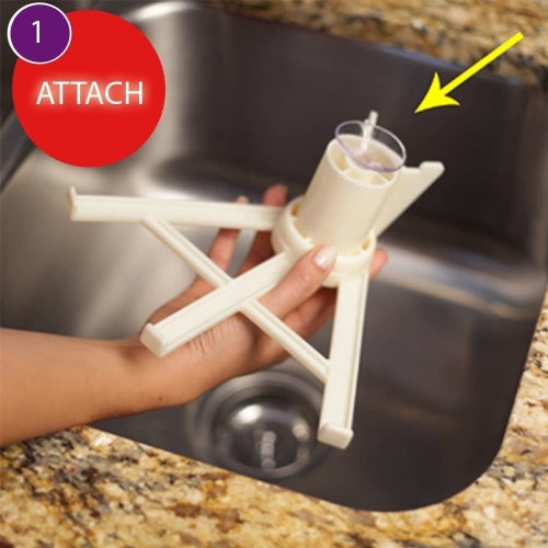 A hand holding the three-pronged claw with a suction cup base with the text 1) Attach