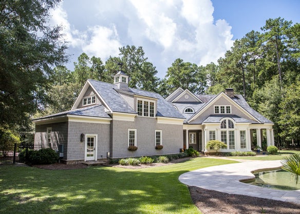 A really big home with a swirly driveway