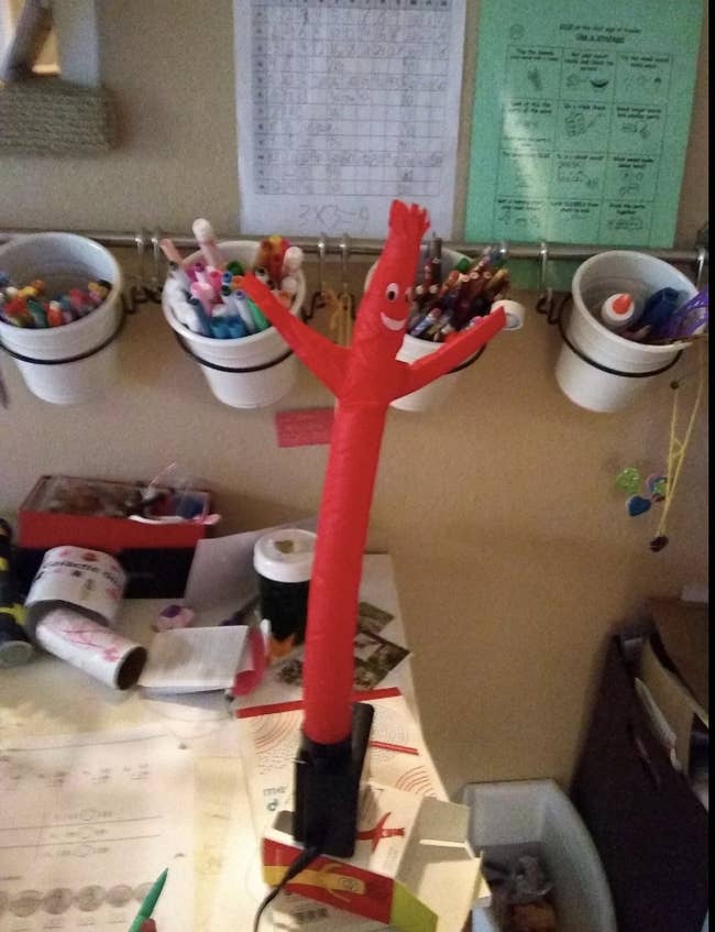 A red inflatable resolve on a desk 