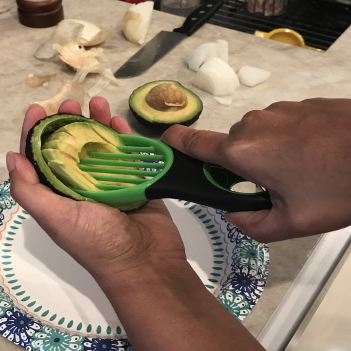 Reviewer using the tool to evenly slice avocado after pitting