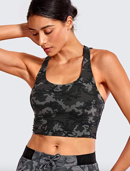 Model wears camo-print gray and black crop top with removable pads