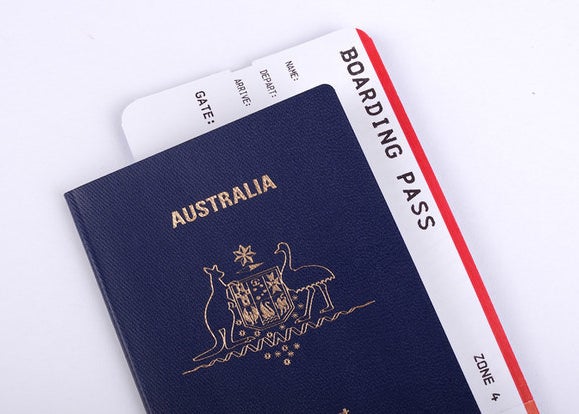 An Australian passport with a boarding pass poking out of its pages