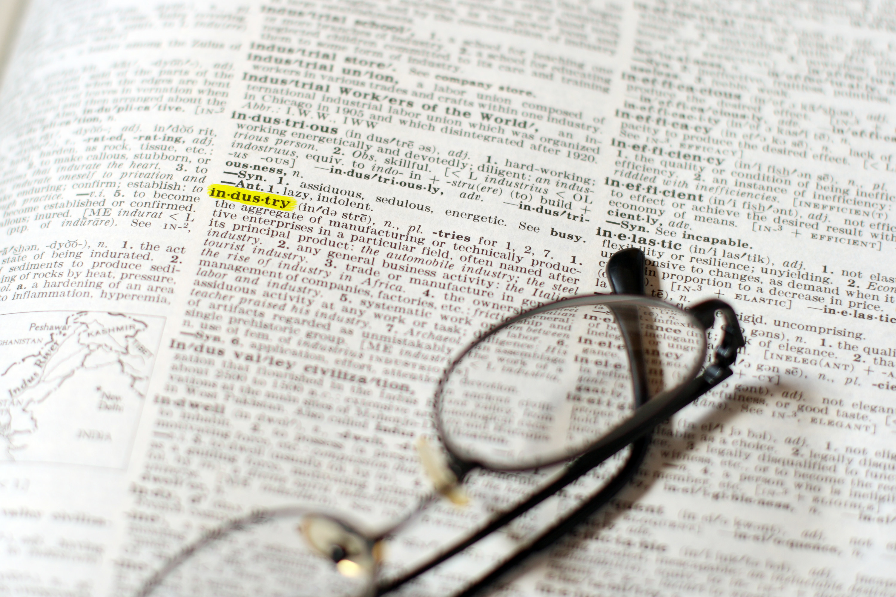 Glasses on an open dictionary 