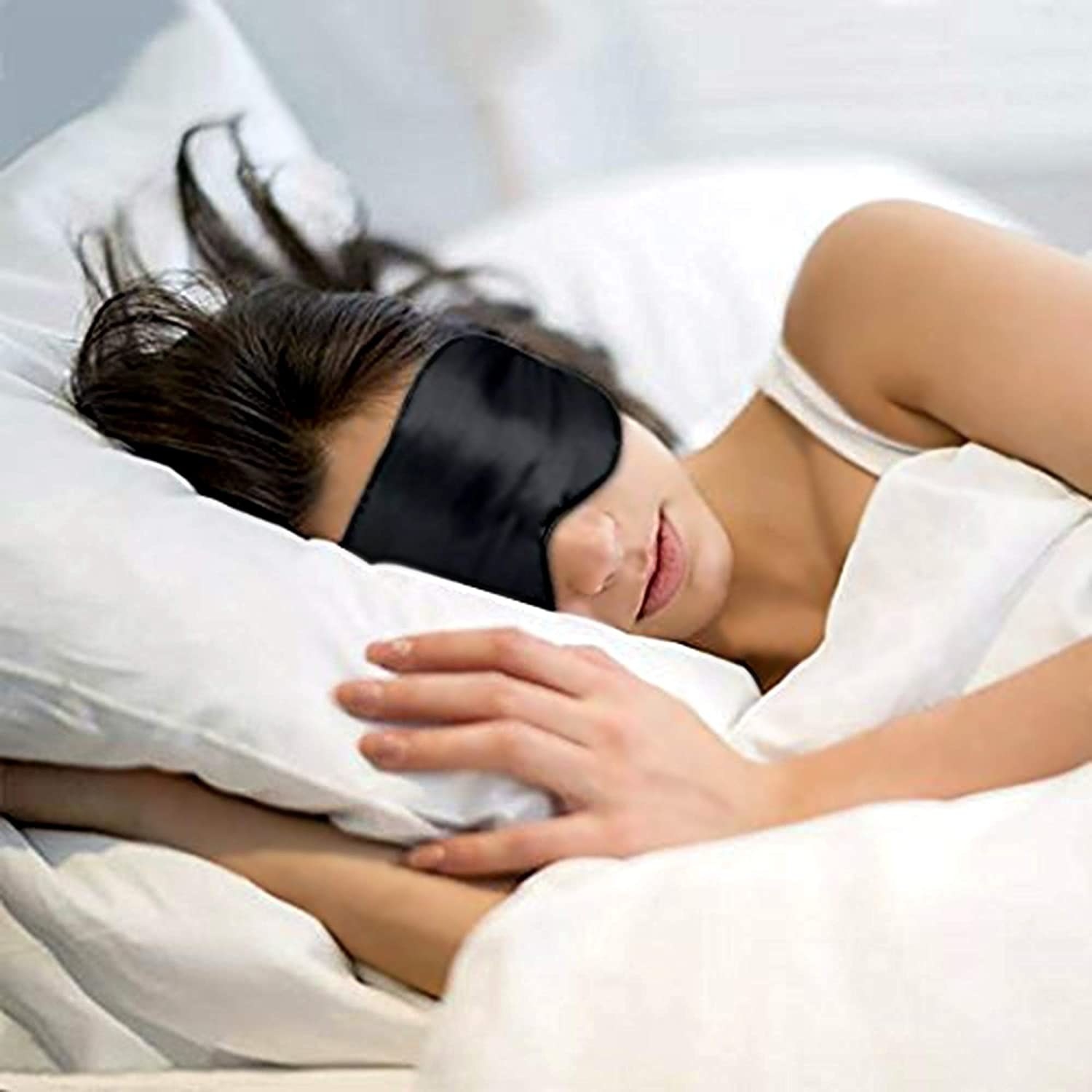 A woman sleeping with the eye mask on.