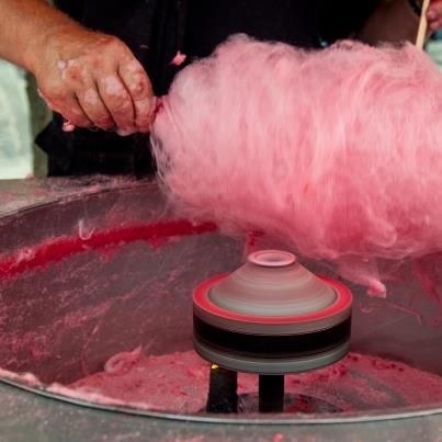 Some cotton candy being prepared in a candy floss machine 