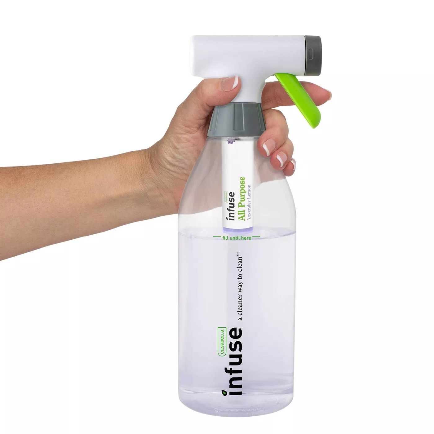"A model holding the trigger on a refillable bottle of Infuse's lavender-scented, all-purpose cleaning spray