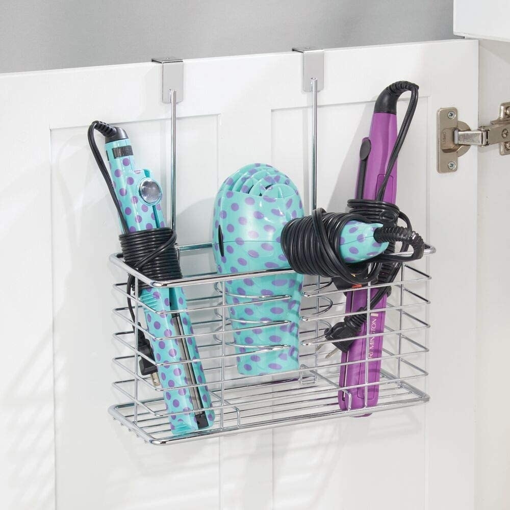an open bathroom cabinet door with a minimalist organizer hung on the cabinet door containing a brush, hair dryer, bottles of hair styling product