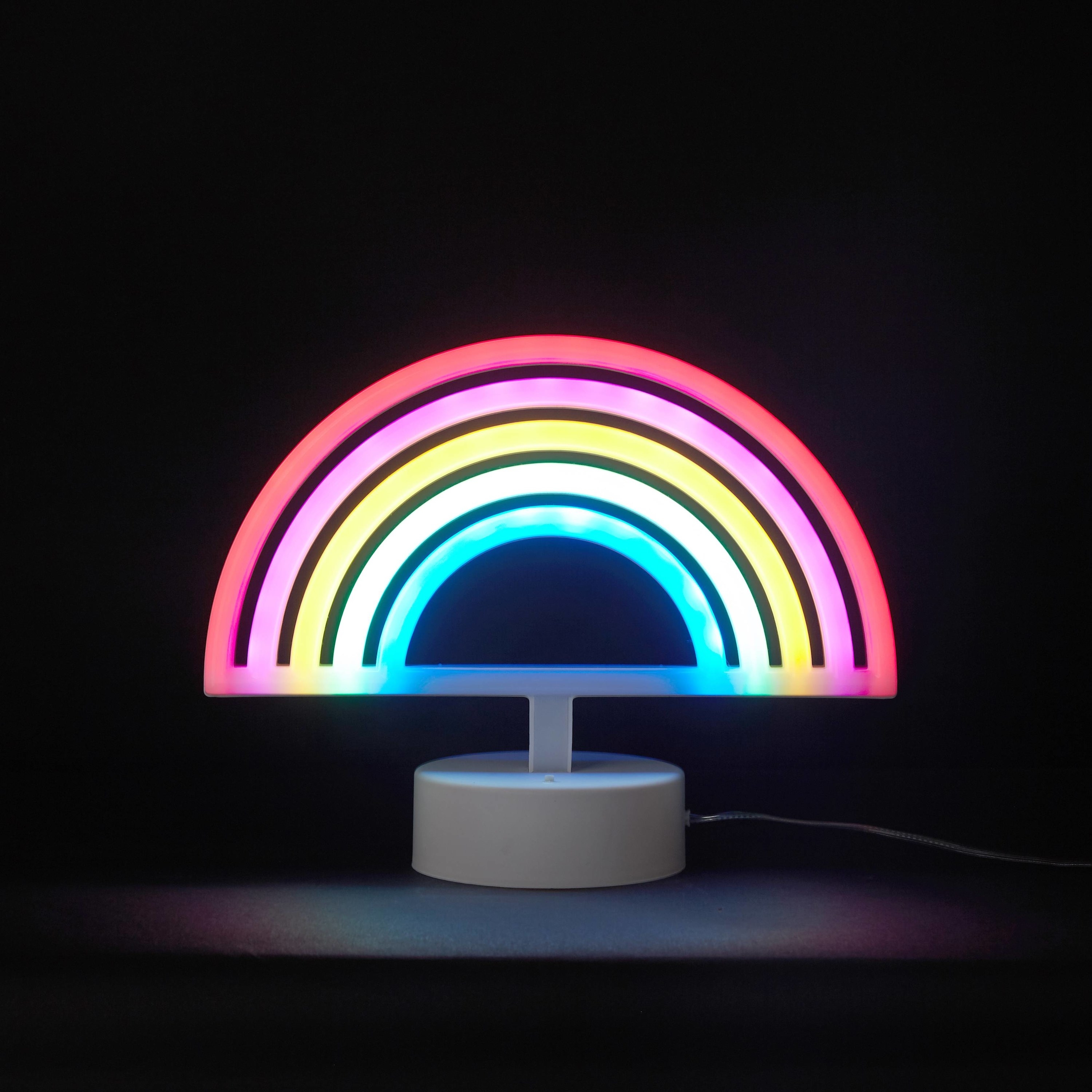 A lit rainbow LED lamp in a dark room