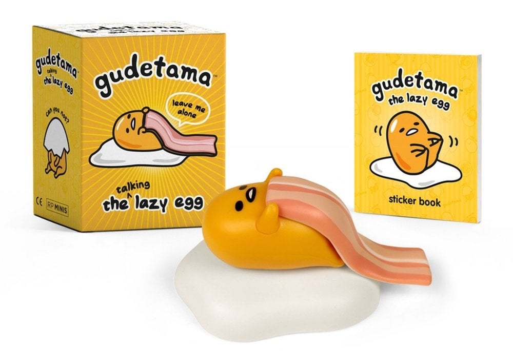 A yellow and white gudetama figurine that uses bacon as a blanket