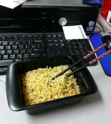 A reviewer's cooked noodles in the maker, which is black and rectangular and can also be used as a bowl