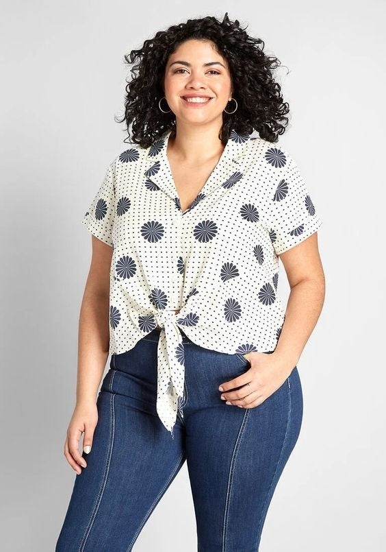 Model in the floral and polka dot short sleeve blouse