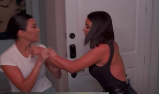 Kourtney holds Kim&#x27;s arm as she lunges at her