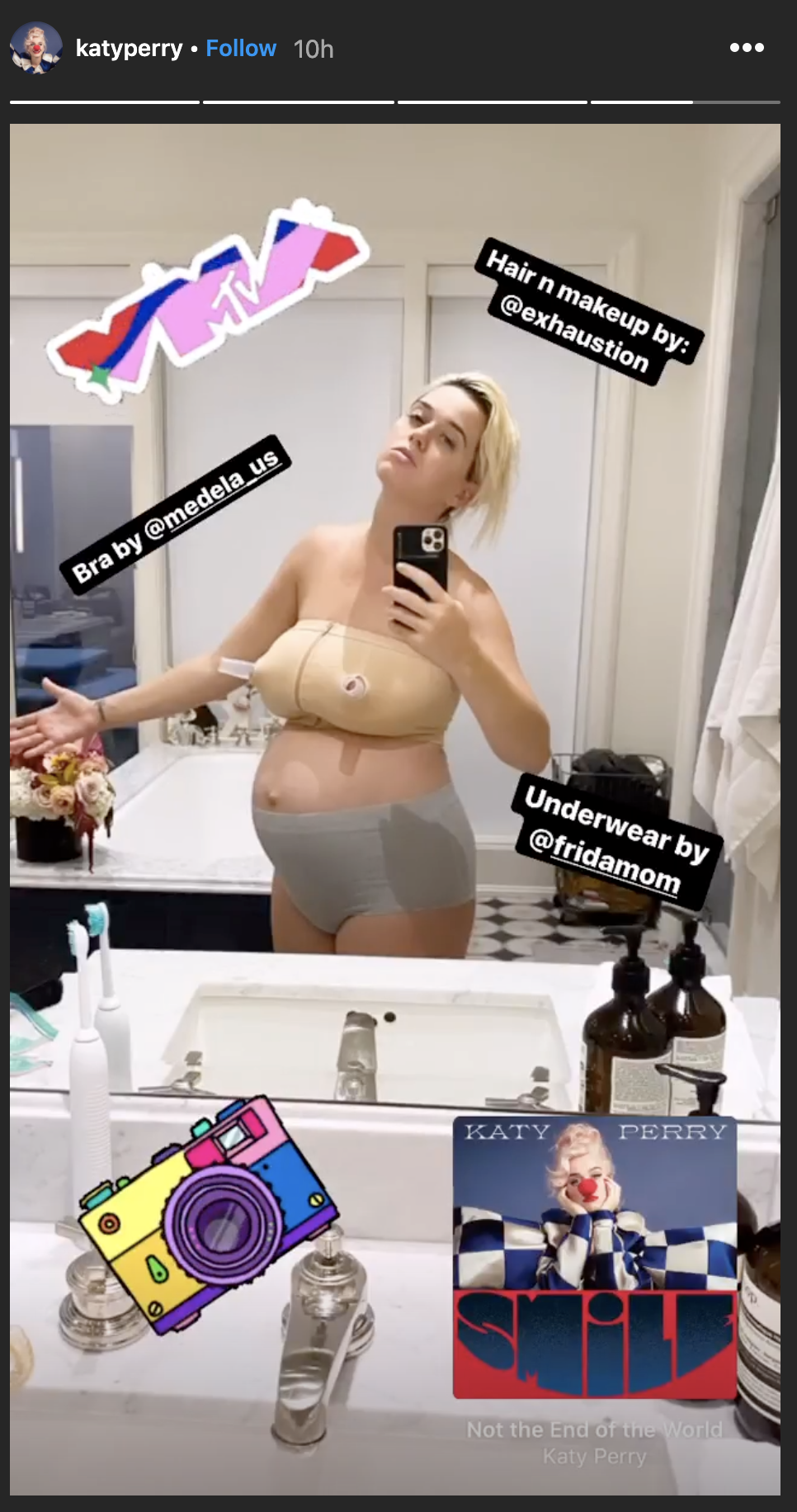 Katy reflected in the mirror, wearing support panties, pumping bra, and the caption &quot;Hair n makeup by @exhaustion&quot;