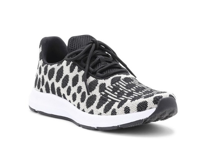 White and black polka dot sneakers with black detailing and white sole