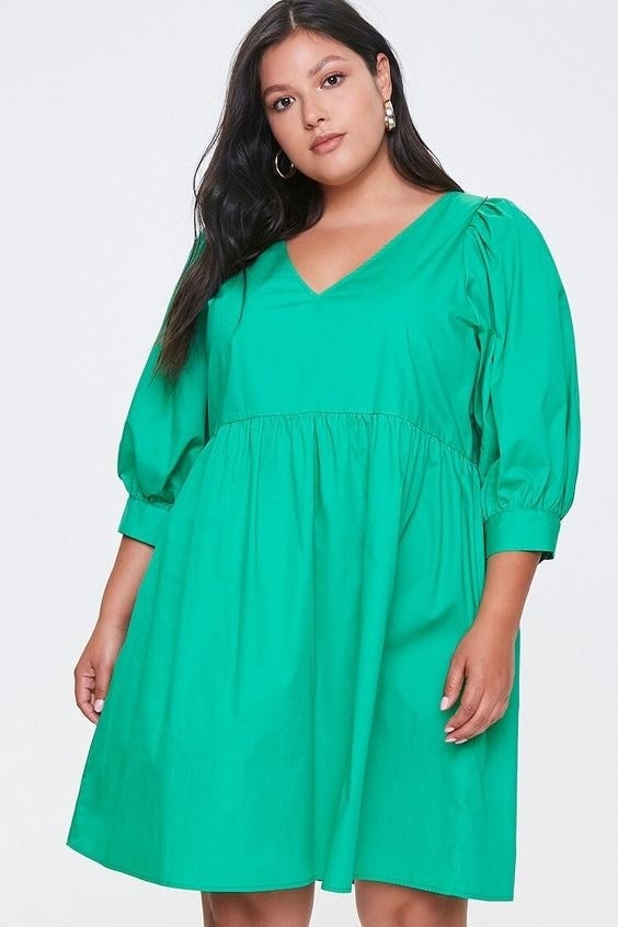 Model wearing the three quarter-length sleeved dress in green