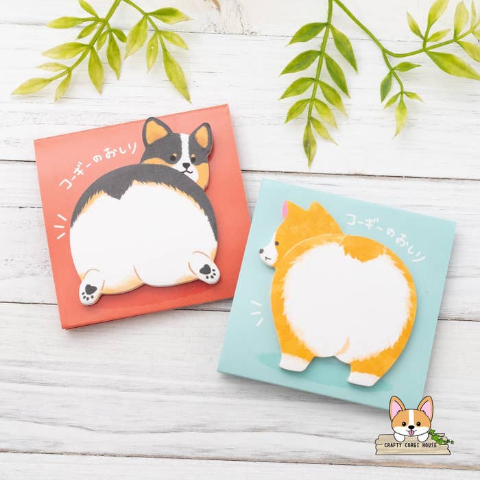 Colorful sticky notes featuring the fluffy butts of a red and a black tri corgi