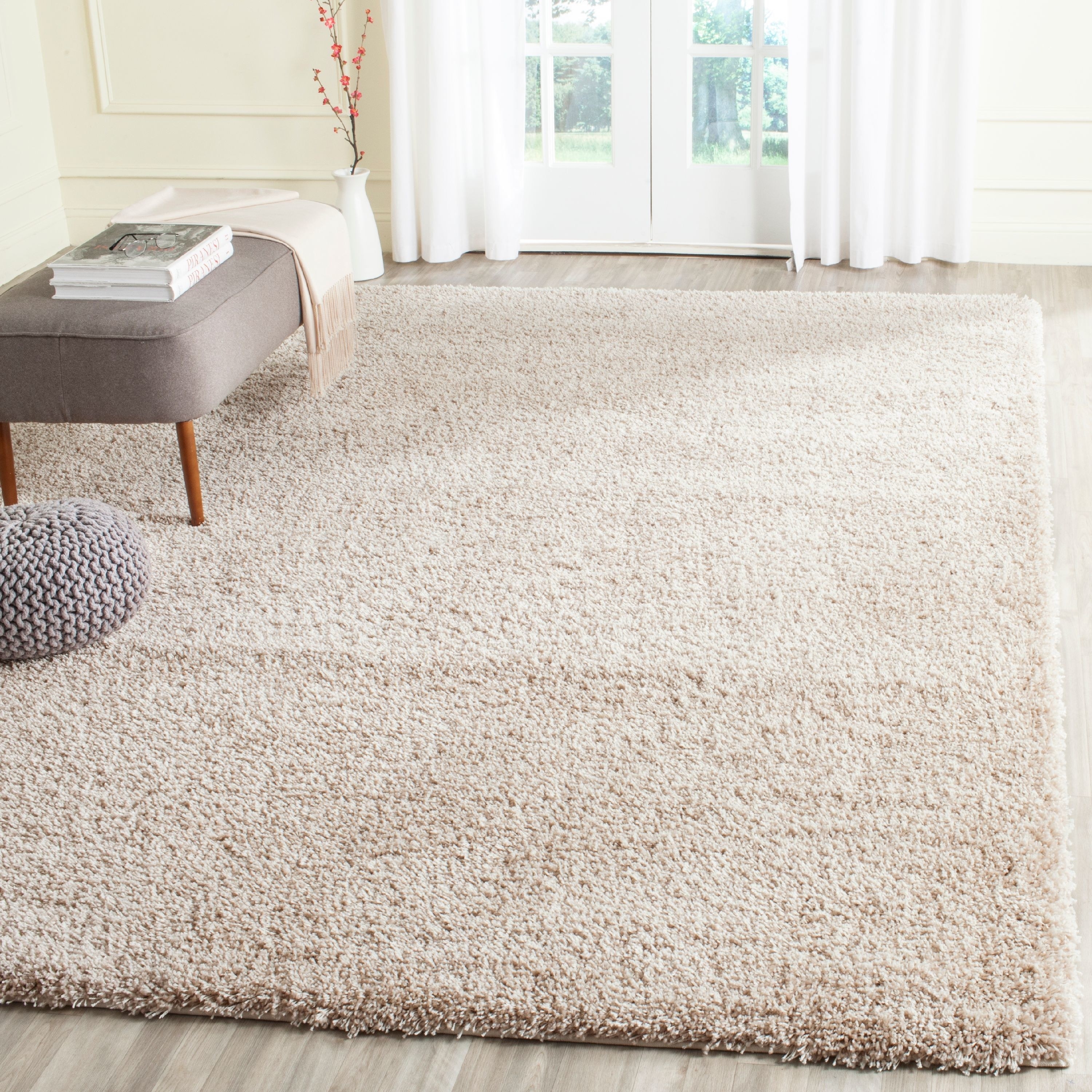 The area rug laid out in a room in beige