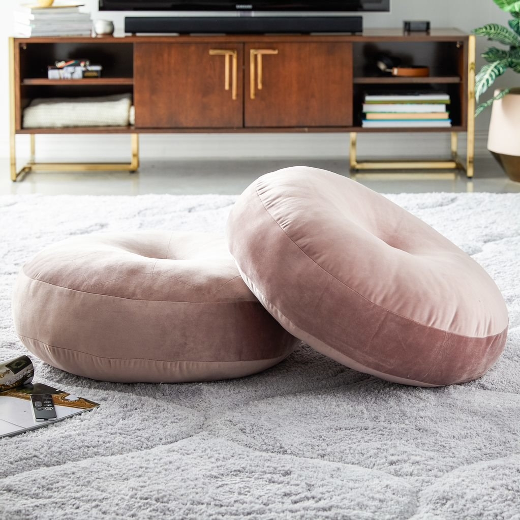 Two pink floor pillows 
