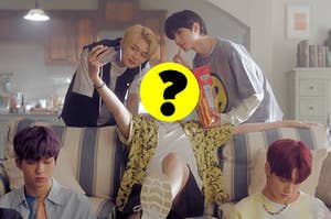 An image from TXT's music video for Can't You See Me with a question mark over Hueningkai's head