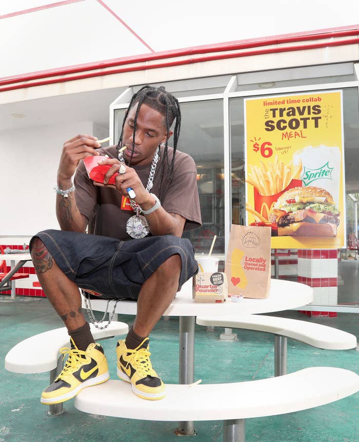 Travis Scott eats fries outside a McDonald&#x27;s, promoting the new Travis Scott Meal