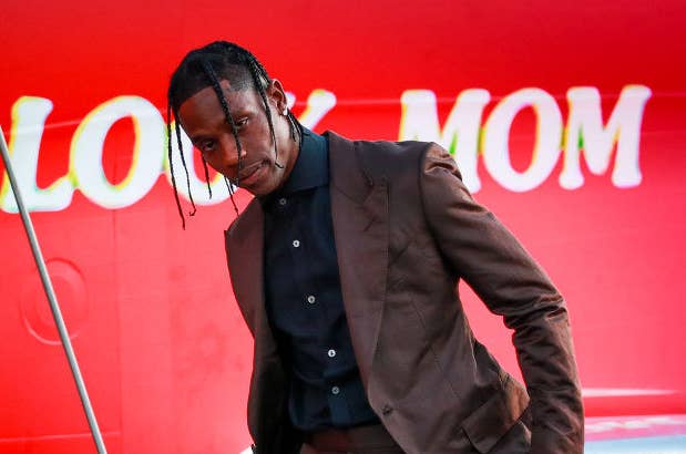 Travis Scott poses outside a private jet
